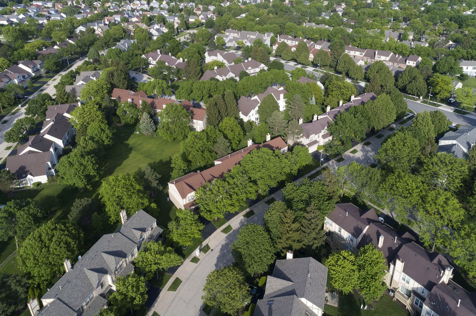 Aerial view of suburban townhouses and single-family homes